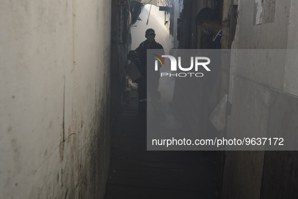 A Thai health officer sprays chemicals to kill mosquitos for the health precaution against dengue fever inside a community in Bangkok, Thail...