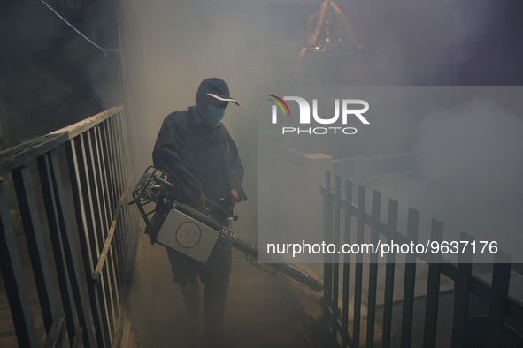 A Thai health officer sprays chemicals to kill mosquitos for the health precaution against dengue fever inside a community in Bangkok, Thail...