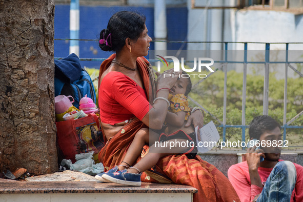 A woman takes care of her two-year-old grandson who is suffering from fever and respiratory problems, at a hospital in Kolkata, on March 01,...