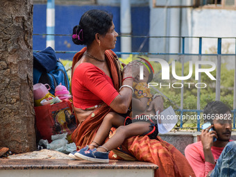 A woman takes care of her two-year-old grandson who is suffering from fever and respiratory problems, at a hospital in Kolkata, on March 01,...