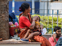 A woman takes care of her two-year-old grandson who is suffering from fever and respiratory problems, at a hospital in Kolkata, on March 01,...