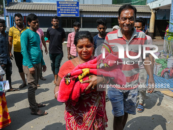 A woman cries as she holds the body of her three-day-old grandson who died from respiratory problems, at a hospital in Kolkata, on March 01,...