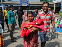 A woman cries as she holds the body of her three-day-old grandson who died from respiratory problems, at a hospital in Kolkata, on March 01,...