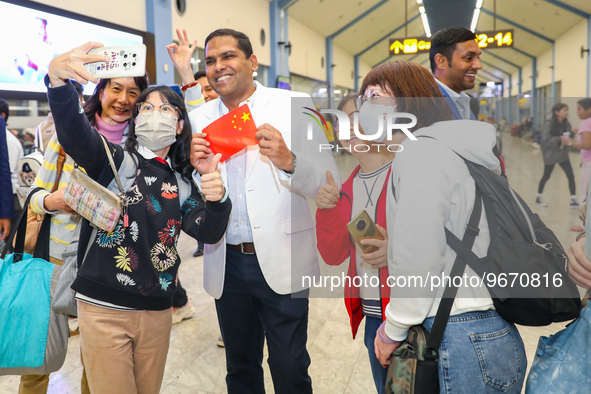 A Chinese tourist takes a selfie with the minister of tourism and lands, Harin Fernando, on March 1, 2023, in Katunayake, Sri Lanka. A Sri L...