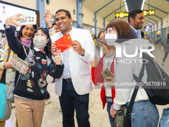 A Chinese tourist takes a selfie with the minister of tourism and lands, Harin Fernando, on March 1, 2023, in Katunayake, Sri Lanka. A Sri L...