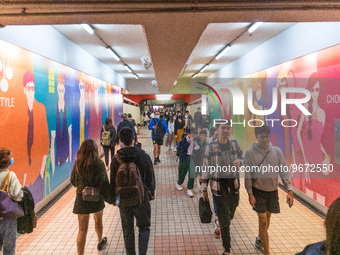 Unmasked commuters walk in a corridor leading to the MTR,in Hong Kong, China, on Mar 1, 2023. (