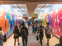 Unmasked commuters walk in a corridor leading to the MTR,in Hong Kong, China, on Mar 1, 2023. (