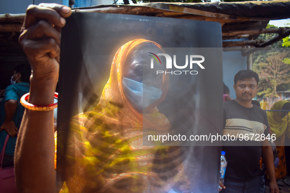 A woman is displaying an x-ray sheet for her child inside a government-run hospital suffering from fever and respiratory problems In Kolkata...