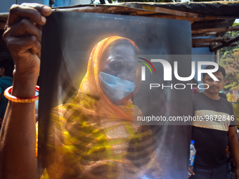 A woman is displaying an x-ray sheet for her child inside a government-run hospital suffering from fever and respiratory problems In Kolkata...