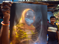 A woman is displaying an x-ray sheet for her child inside a government-run hospital suffering from fever and respiratory problems In Kolkata...