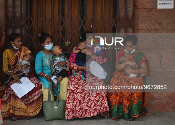 Patients and their relatives wait for treatment at a outside a Emergency ward  in government-run hospital for suffering from fever and respi...