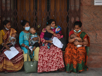 Patients and their relatives wait for treatment at a outside a Emergency ward  in government-run hospital for suffering from fever and respi...