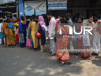 People wait in queue as they have come for a health check-up of their children, who are suffering from fever and respiratory problems, at a...