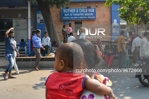 People are seen with children in front of a pediatric department at a government run hospital in Kolkata , India , on 3 March 2023 .  Kolkat...