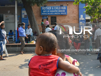 People are seen with children in front of a pediatric department at a government run hospital in Kolkata , India , on 3 March 2023 .  Kolkat...