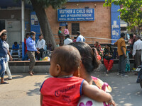 People are seen with children in front of a pediatric department at a government run hospital in Kolkata , India , on 3 March 2023 .  Kolkat...