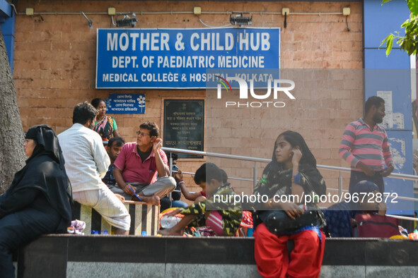 People are seen with children in front of a pediatric department at a government run hospital in Kolkata , India , on 3 March 2023 .  Kolkat...