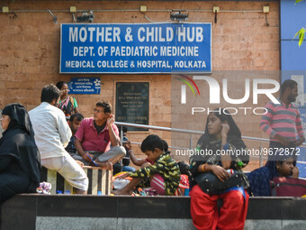 People are seen with children in front of a pediatric department at a government run hospital in Kolkata , India , on 3 March 2023 .  Kolkat...