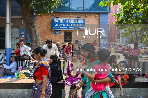 People are seen with children in front of a pediatric department at a government run hospital in Kolkata , India , on 3 March 2023 .  Kolkat...