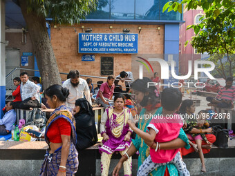 People are seen with children in front of a pediatric department at a government run hospital in Kolkata , India , on 3 March 2023 .  Kolkat...