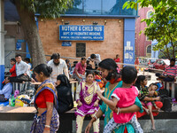 People are seen with children in front of a pediatric department at a government run hospital in Kolkata , India , on 3 March 2023 .  Kolkat...