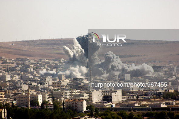 Flames rise from an explosion in the Syrian town of Kobane, also known as Ain al-Arab, after a US-led coalition airstrike as it seen from th...