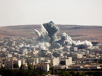 Flames rise from an explosion in the Syrian town of Kobane, also known as Ain al-Arab, after a US-led coalition airstrike as it seen from th...