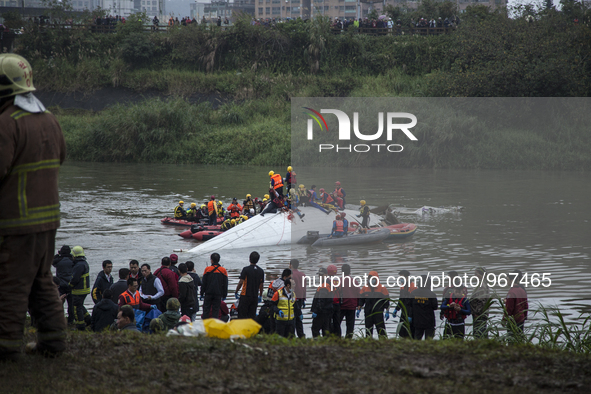 Rescue team and debris of a commercial airplane ATR72 operated by a Taiwanese airlines TransAir, that crashes into a river shortly after tak...