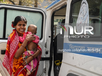 A woman reacts as she holds her three-year-old son who is suffering from respiratory problems, at a hospital in Kolkata on March 02, 2023. T...