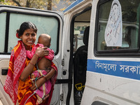 A woman reacts as she holds her three-year-old son who is suffering from respiratory problems, at a hospital in Kolkata on March 02, 2023. T...