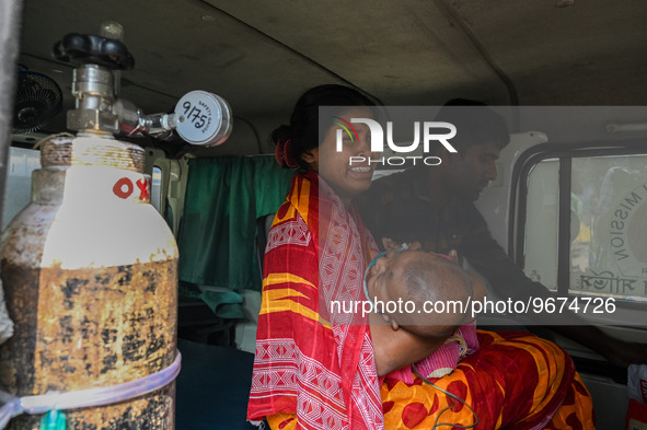 A woman reacts as she holds her three-year-old son who is suffering from respiratory problems, at a hospital in Kolkata on March 02, 2023. T...