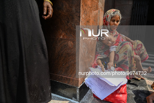 A woman sits with her grandson who is suffering from respiratory problems, at a hospital in Kolkata, on March 02, 2023. The eastern Indian s...