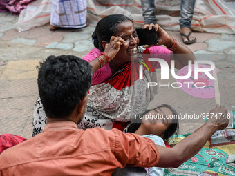 A woman reacts to the death of her three-month-old granddaughter who was undergoing treatment for respiratory problems, at a hospital in Kol...