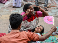 A woman reacts to the death of her three-month-old granddaughter who was undergoing treatment for respiratory problems, at a hospital in Kol...