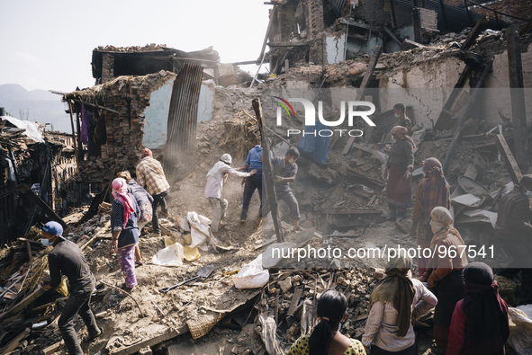 Survivors of the 2015 Nepal earthquake begin to search through the rubble of damaged buildings by hand, Tibukche Tol, Bhaktapur, Nepal. An e...