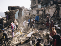 Survivors of the 2015 Nepal earthquake begin to search through the rubble of damaged buildings by hand, Tibukche Tol, Bhaktapur, Nepal. An e...