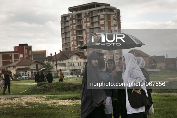 PRISTINA, KOSOVO-- May 26, 2015- Women gather in a field where a  funeral was held for eight ethnic Albanian gunman killed in clashes with p...