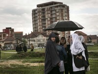 PRISTINA, KOSOVO-- May 26, 2015- Women gather in a field where a  funeral was held for eight ethnic Albanian gunman killed in clashes with p...