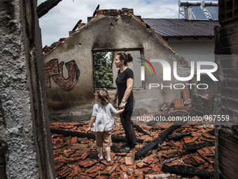 KUMANOVO, KOSOVO-- May 27, 2015- Zerije Asana and her niece Blina, 4, inside her family's destroyed home in Kumanovo, Macedonia.  The family...