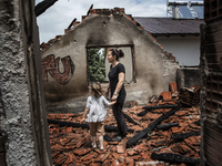 KUMANOVO, KOSOVO-- May 27, 2015- Zerije Asana and her niece Blina, 4, inside her family's destroyed home in Kumanovo, Macedonia.  The family...