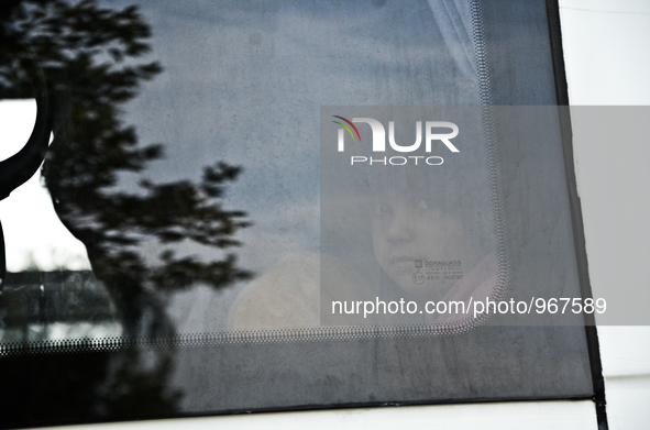 A girl looks out of a window in Edirne, Turkey on September 22, 2015. The European Union approves a plan to share 120,000 refugees across it...