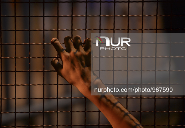 A migrant awaiting to enter to the transfer camp in Opatovac near the border crossing point between Serbia and Croatia, on September 22, 201...