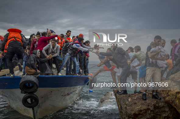 Refugees and Migrants aboard fishing boat drived by smugglers reach the Greek Island coast of Lesbos after crossing the Aegean sea from Turk...