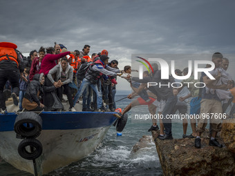 Refugees and Migrants aboard fishing boat drived by smugglers reach the Greek Island coast of Lesbos after crossing the Aegean sea from Turk...