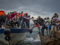 Refugees and Migrants aboard fishing boat drived by smugglers reach the Greek Island coast of Lesbos after crossing the Aegean sea from Turk...