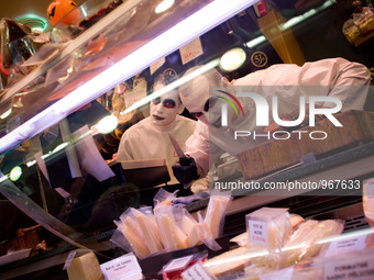 Vendors dressed in their Halloween costumes  pose for a photo at Santa Caterina Market in Barcelona, Spain on 31 October, 2015. (