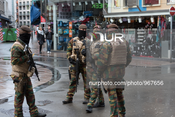 Soldiers and police officers in Brussels, on November 21, 2015. Brussels will remain at the highest possible alert level today, with schools...