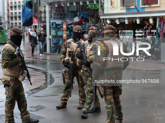 Soldiers and police officers in Brussels, on November 21, 2015. Brussels will remain at the highest possible alert level today, with schools...