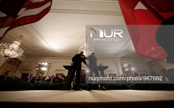 French President Francois Hollande (R) and U.S. President Barack Obama (L) embrace during a joint press conference in the East Room of the W...