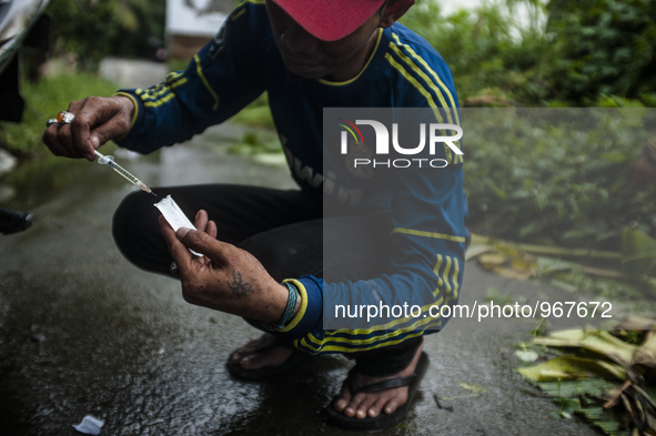 A junkies man, Dicky (33) and Hadi (42) where people live with HIV using the injection drug substitute for heroin addiction roadside in Meda...